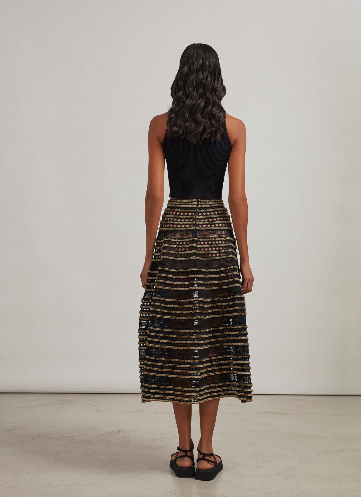Sleeveless knit and lurex sweater ALAÏA BLACK/GOLD SLEEVELESS KNIT AND LUREX SWEATER